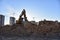 Excavator working at construction site. Backhoe during earthworks. Digging ground for the foundation and for laying sewer pipes