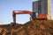 Excavator working at construction site. Backhoe during earthworks. Digging ground for the foundation and for laying sewer pipes