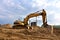 Excavator working at construction site. Backhoe during earthworks. Digging ground for the foundation and for laying sewer pipes