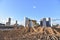 Excavator working at construction site on earthworks. Backhoe digging building foundation. Paving out sewer line. Heavy machinery