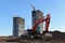 Excavator working at construction site on earthworks. Backhoe on road work digs ground. Paving out sewer line. Construction