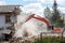 excavator working at the demolition of an old residential building