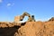 Excavator working on earthmoving at open pit mining. Backhoe digs gravel in quarry. Construction machinery for excavation, loading