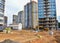 Excavator working at largest construction site. Backhoe on earthworks. Tracked loader laying external sewer pipes. Sewage drainage