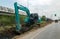 Excavator working beside a road.