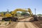 Excavator working on road.