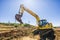 Excavator working on road.