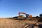 Excavator Working On Road Construction in City. Backhoe on Earthworks. Heavy Construction Equipment Machines in Action. Big Red