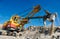 Excavator works with granite or ore at opencast mining