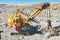 Excavator works with granite or ore at opencast mining