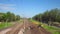 Excavator works near the railroad. Time lapse, tilt-shift. Yellow vehicle bulldozer digging earth