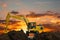 Excavators  in the construction site on the sunset background