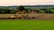 Excavators in field on village background.Pipe laying.Construction machinery and construction work in the field