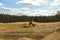 Excavators at a Sand Quarry. Big orange digger in open sand mine is waiting for new shift.