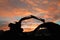 Excavators silhouette are digging the soil in the construction site area  on tunnel.