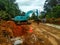 Excavators are at work dredging soil and rock for road widening