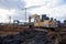 Excavators working at construction site on earthworks. Backhoe digging building foundation. Paving out sewer line. Construction