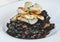 An excellent gourmet dish of seafood paella with squid ink and black rice