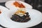 An excellent gourmet dish of seafood paella with squid ink and black rice