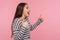 Excellent job, I like it! Side view of joyful excited woman in striped sweatshirt doing thumbs up and shouting in happiness