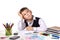 Excellent pupil thinking over the puzzle sitting at the studing desk with white background