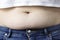 Excess fat on the abdomen close up, the concept of weight loss