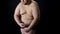 Excess weight male posing pretending to be muscular, cellulite and stretch marks