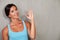 Excited adult woman showing ok sign