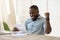 Excited african businessman student read letter happy about good news