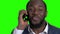 Excited Afro American businessman talking on phone.
