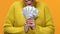 Excited afro-american female showing dollars on bright background, investment