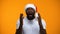 Excited Afro-American man in Santa hat, Christmas magic, yellow background