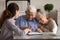 Excited aged married couple sign financial deal with bank manager