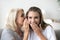 Excited aged mother share secret with adult daughter