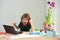 Excited amazed school boy doing homework. Little boy learns with laptop in study room.