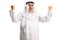 Excited arab man with wearing dishdasha and gesturing happiness