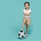 Excited Asian little girl playing football
