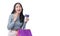 Excited asian showing credit card holding shopping bags in arm standing white background. Cheerful shopper girl using plastic card