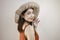 Excited Asian woman in straw hat having beach vacation,  over white studio background