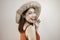 Excited Asian woman in straw hat having beach vacation,  over white studio background