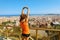 Excited attractive young woman in sportswear stretching enjoying Barcelona landscape in the morning.