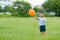 Excited Baby boy hold with orange balloon