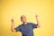 excited bald man with two fingers pointing up