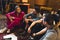 Excited band members sitting together on a carpet. Female vocalist talking to her band partners about a new song idea.