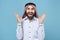 Excited bearded young arabian muslim man in keffiyeh kafiya ring igal agal casual clothes isolated on pastel blue