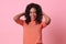 Excited beautiful african woman happiness wearing casual orange t-shirt isolated on pink background