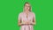 Excited beautiful young woman in pink dress talking to camera on a Green Screen, Chroma Key.