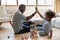 Excited biracial dad and son give high five playing