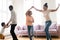 Excited biracial family with kids have fun dancing at home