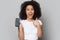 Excited biracial girl show amazing deal on cellphone screen